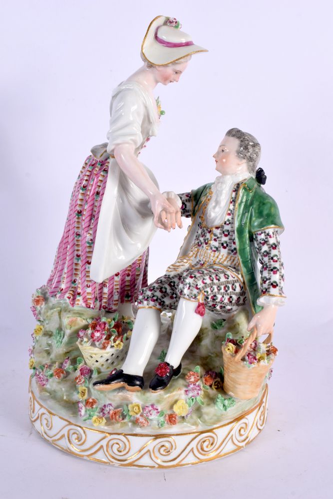 A 19TH CENTURY MEISSEN PORCELAIN FIGURAL GROUP depicting a gallant and female amongst foliage. 22 cm