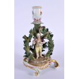 A VERY RARE 19TH CENTURY MEISSEN PORCELAIN CHAMBERSTICK formed as a standing figure under foliage. 1