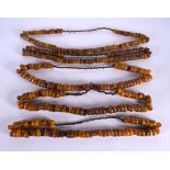FIVE MIDDLE EASTERN CARVED AMBER PRAYER BEAD NECKLACES. 611 grams. 64 cm long. (5)