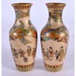 A FINE PAIR OF 19TH CENTURY JAPANESE MEIJI PERIOD SATSUMA VASES painted with figures in landscapes.