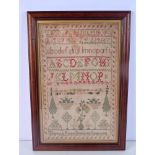 A MID 19TH CENTURY FRAMED AND EMBROIDERED SAMPLER by Elizabeth Brown C1842. 52 cm x 42 cm.