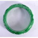 A CHINESE CARVED JADE BANGLE 20th Century. 7.5 cm diameter.