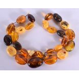 A VINTAGE AMBER NECKLACE. 90 grams. 72 cm long, largest bead 3.5 cm x 2.75 cm.