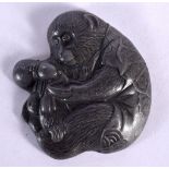 A 19TH CENTURY JAPANESE MEIJI PERIOD MIXED METAL PLAQUE modelled as a monkey pouring a gourd. 6.5 cm