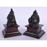 A SMALL PAIR OF 19TH CENTURY MIDDLE EASTERN BRONZE FIGURES depicting buddhas 11 cm high.