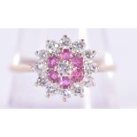 A 9CT GOLD DIAMOND AND RUBY CLUSTER RING. 2.4 grams. S.