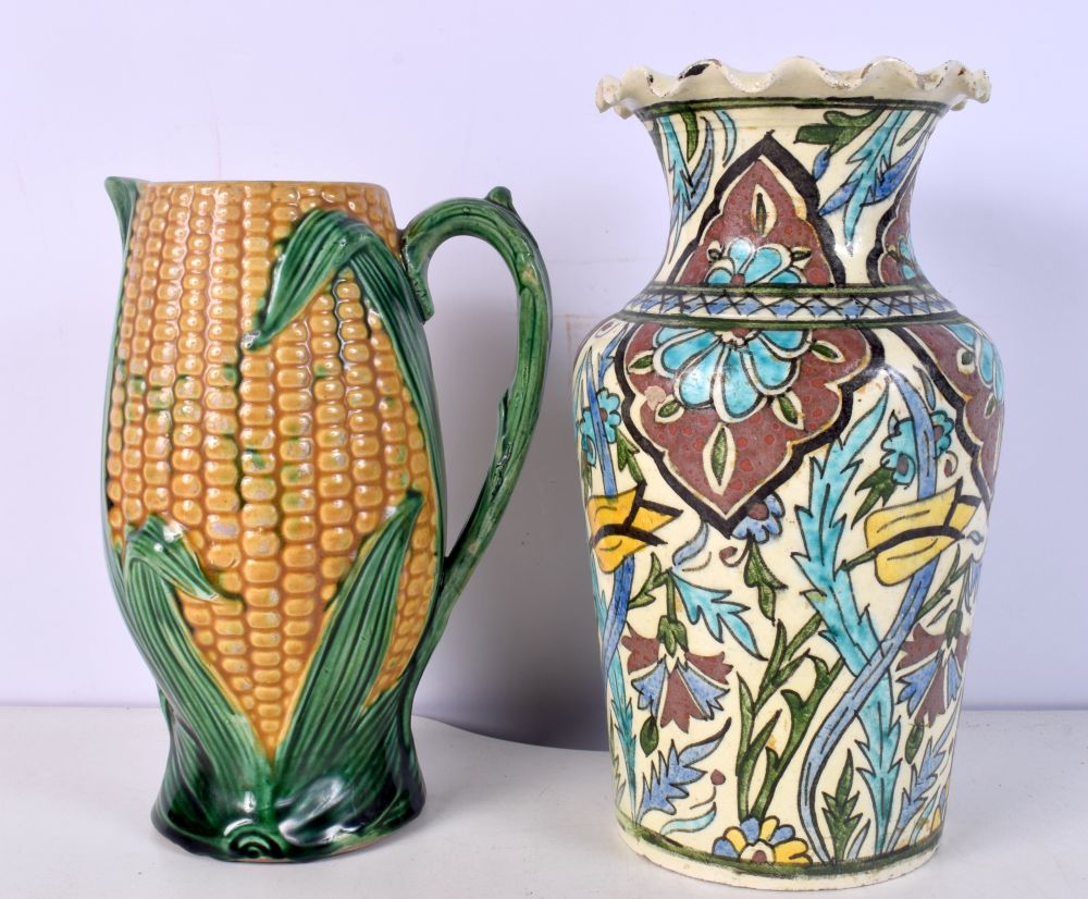 A TURKISH MIDDLE EASTERN IZNIK TYPE VASE and a majolica corn jug. Largest 26.5 cm high. (2)