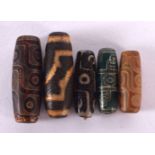 FIVE CHINESE TIBETAN AGATE ZHI BEADS 20th Century. Largest 4 cm long. (5)