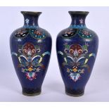 A PAIR OF EARLY 20TH CENTURY JAPANESE MEIJI PERIOD CLOISONNE ENAMEL VASES decorated with foliage. 16