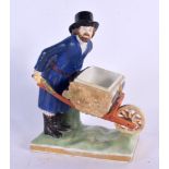 A RARE ANTIQUE RUSSIAN PORCELAIN FIGURE OF A MALE modelled holding a barrow upon a naturalistic base