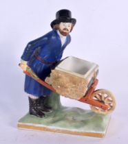 A RARE ANTIQUE RUSSIAN PORCELAIN FIGURE OF A MALE modelled holding a barrow upon a naturalistic base