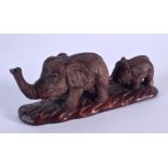 A JAPANESE CARVED WOOD ELEPHANT OKIMONO. 12 cm x 4 cm.