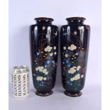 A LARGE PAIR OF LATE 19TH CENTURY JAPANESE MEIJI PERIOD CLOISONNE ENAMEL VASES decorated with foliag