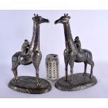 A PAIR OF EARLY 20TH CENTURY PEWTER FIGURES OF GIRAFFES in the manner of WMF. 30 cm high.