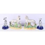 A pair of 19th Century Staffordshire Zebra together with two porcelain dalmatians