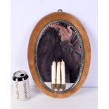 A vintage small velvet surround mirror with attached candle holders 37 x 26 cm.