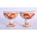 A PAIR OF 19TH CENTURY CHINESE IRON RED PORCELAIN STEM CUPS Qing, painted with dragons. 9 cm x 8.5 c
