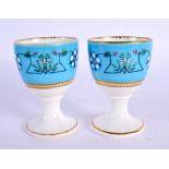 Royal Worcester pair of egg cups decorated after Sir Christopher Dresser with a typical style on a t