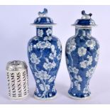 A PAIR OF 19TH CENTURY CHINESE BLUE AND WHITE PORCELAIN VASES AND COVERS bearing Kangxi marks to bas