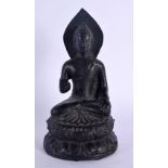 AN EARLY 20TH CENTURY SOUTH EAST ASIAN BUDDHA modelled with one hand raised. 15 cm high.