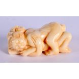 A JAPANESE CARVED BONE EROTIC NETSUKE. 5 cm x 3 cm.