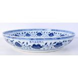 A Chinese porcelain blue and white charger decorated with plum blossom and foliage 34cm.