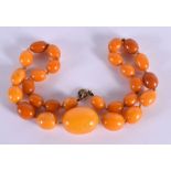 A VINTAGE AMBER NECKLACE. 24.5 grams. 42 cm long, largest bead 2 cm x 1.5 cm.