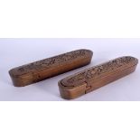 A PAIR OF TURKISH MIDDLE EASTERN CARVED WOOD PEN BOXES AND COVERS decorated with flowers. 24 cm long