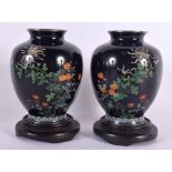 A PAIR OF EARLY 20TH CENTURY JAPANESE SILVER MOUNTED CLOISONNE ENAMEL VASES decorated with foliage.
