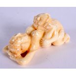 A JAPANESE CARVED BONE EROTIC NETSUKE. 5 cm x 3 cm.