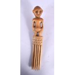 A RARE 19TH CENTURY AFRICAN CARVED BONE TRIBAL COMB formed with a standing figure.18 cm long.