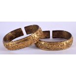 A RARE PAIR OF EARLY 20TH CENTURY CHINESE TIBETAN BRONZE BANGLES possibly made for the Islamic marke