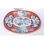 A Chinese porcelain dish decorated with panels containing birds in foliage 27 x 22 cm .