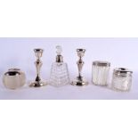 THREE ANTIQUE SILVER TOPPED JARS together with a silver mounted scent bottle & a pair of silver cand