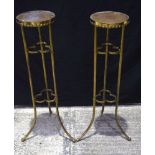A pair of Arts and Crafts brass pot stands 93 cm (2).