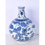 A Chinese porcelain blue and white moon flask decorated with plum blossom , banana leaf and bamboo