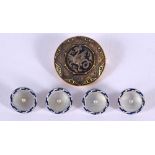 FOUR ART DECO BUTTONS and a griffin brooch. 12 grams. Largest 2.75 cm diameter. (5)