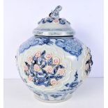 A large Chinese porcelain Ginger jar and cover decorated in relief with red underglaze plum blossom