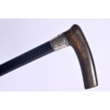 AN ANTIQUE SILVER MOUNTED RHINOCEROS HORN HANDLED WALKING CANE. London 1911. 90 cm long.