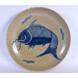 AN UNUSUAL 19TH CENTURY CHINESE CRACKLE GLAZED PORCELAIN DISH painted with a fish. 25 cm diameter.