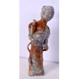 AN UNUSUAL CHINESE CARVED GREYISH JADE FIGURE OF A FEMALE. 18 cm high.