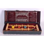 A BOXED BUSSEYS TABLE CROQUET SET. 27 cm wide.