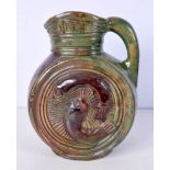 An Arts & Crafts glazed pottery jug decorated with cat fish 25 cm.