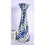 A LARGE MIDDLE EASTERN TURKISH FLARED POTTERY VASE painted with spiralised flowers and vines. 40 cm