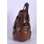A CHINESE QING DYNASTY CARVED BAMBOO FIGURE OF A BUDDHA modelled upon a toad. 22 cm x 10 cm.