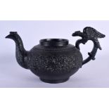 AN EARLY 19TH CENTURY ENGLISH BLACK POTTERY TEAPOT decorated with foliage and vines. 17 cm wide.