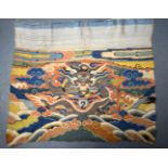 A 17TH CENTURY CHINESE ORANGE SILK WORK BROCADE PANEL Ming/Qing, depicting dragons. 90 cm x 72 cm.