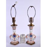A PAIR OF CONTINENTAL PORCELAIN COUNTRY HOUSE ARMORIAL LAMPS. 49 cm high.