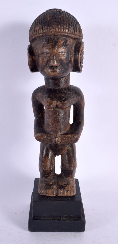 AN AFRICAN TRIBAL CARVED WOOD FIGURE. 28 cm high.