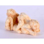 A JAPANESE CARVED BONE EROTIC NETSUKE. 6 cm x 4 cm.